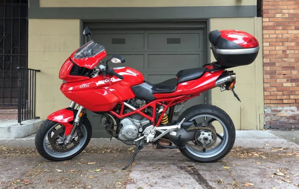 Ducati-Multistrada-with-top-box-parked-in-front-of-garage-1024x649.webp