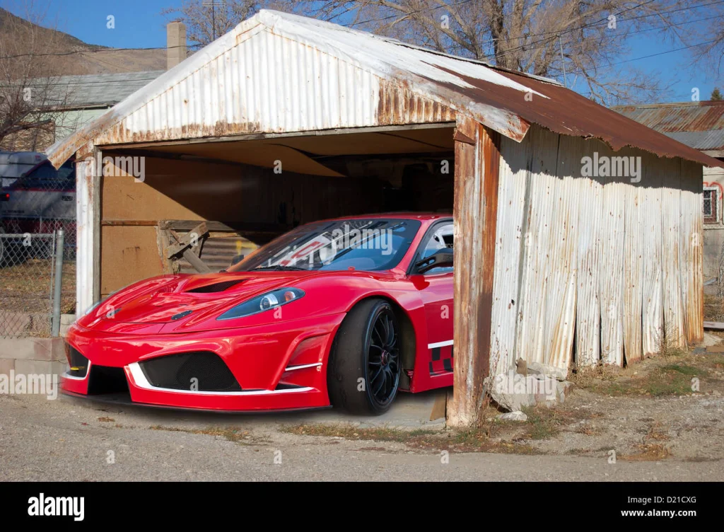 ferrari-in-old-rusty-building-barn-D21CXG.webp