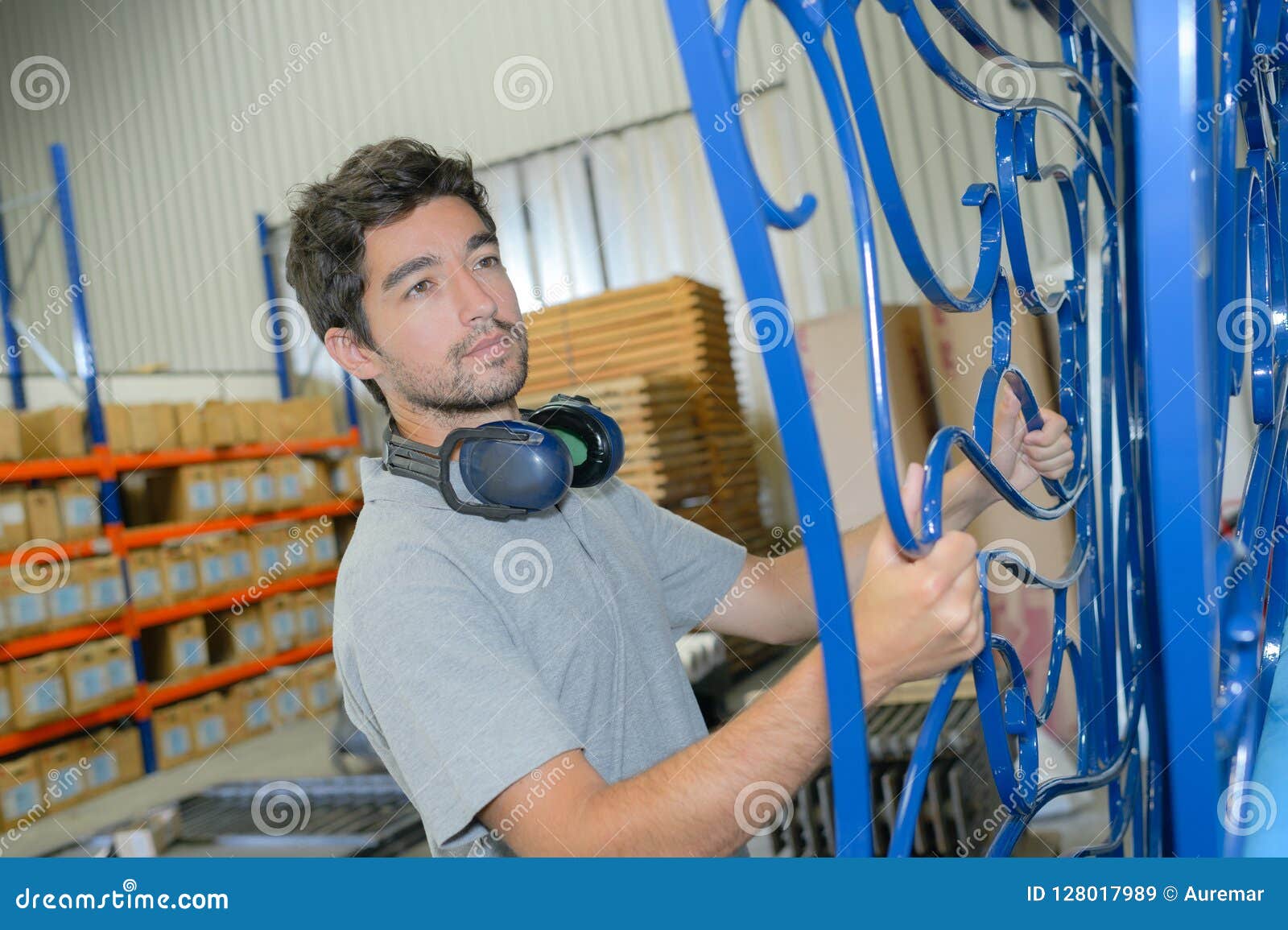 man-holding-metal-gate-metal-man-holding-metal-gate-128017989.jpg